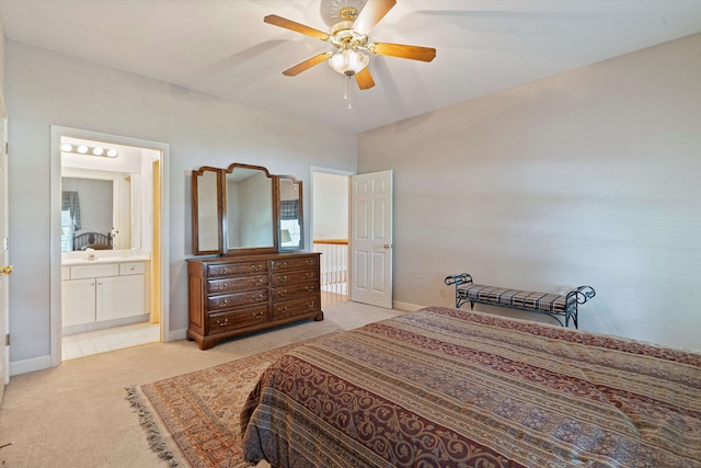 carpeted bedroom featuring ensuite bath and ceiling fan