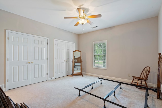 sitting room with ceiling fan and light carpet