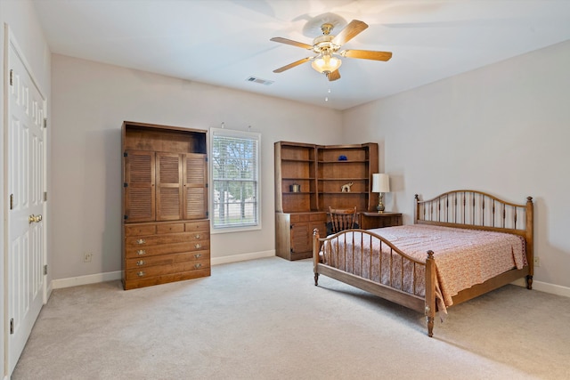 bedroom featuring ceiling fan, light colored carpet, and a closet