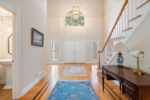 entrance foyer featuring a high ceiling and light hardwood / wood-style floors