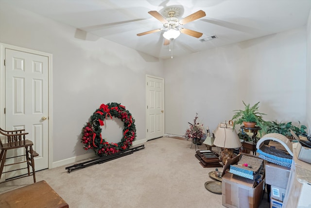 miscellaneous room with ceiling fan and light colored carpet