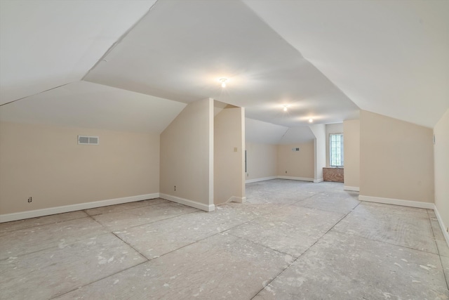 additional living space featuring vaulted ceiling