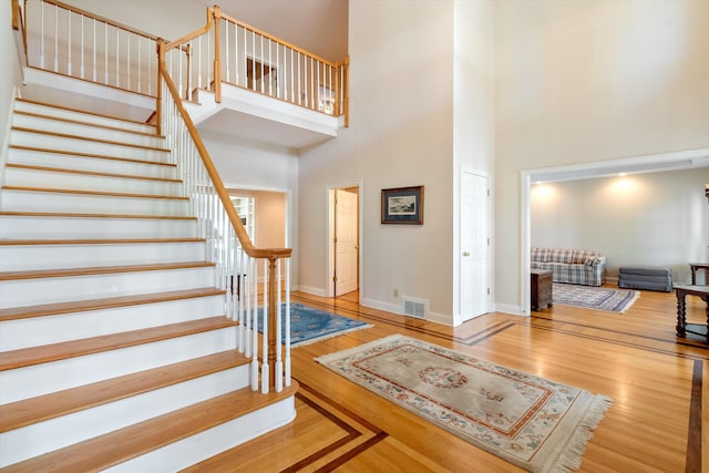 foyer entrance featuring a high ceiling and hardwood / wood-style flooring