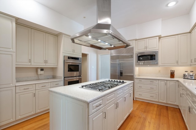 kitchen with light hardwood / wood-style floors, island range hood, a kitchen island, and built in appliances