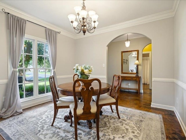 dining space featuring a notable chandelier, dark hardwood / wood-style floors, and ornamental molding