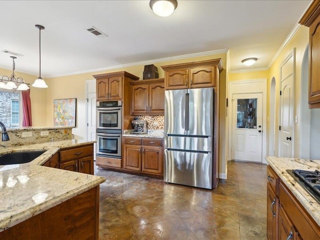 kitchen with hanging light fixtures, sink, tasteful backsplash, appliances with stainless steel finishes, and crown molding