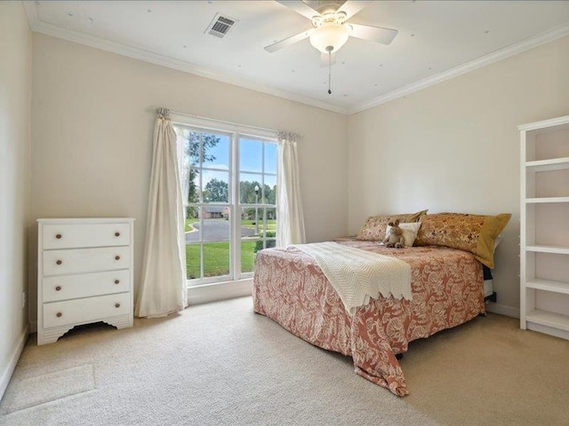 bedroom featuring ceiling fan, light colored carpet, and crown molding