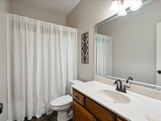 bathroom featuring vanity, toilet, and a shower with shower curtain