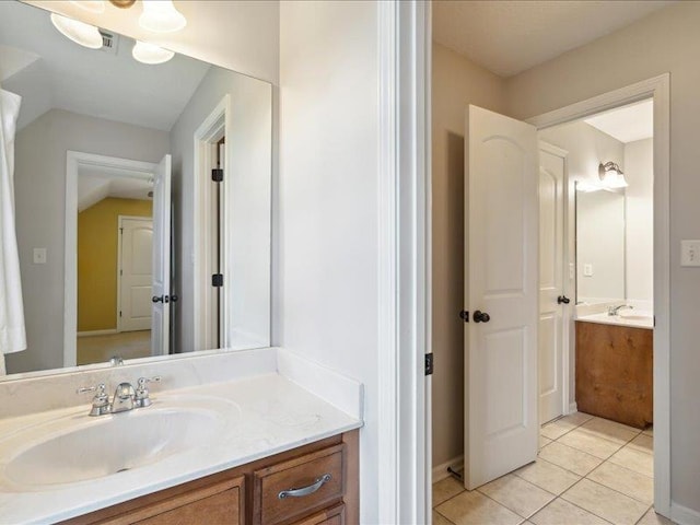 bathroom with tile patterned flooring and vanity