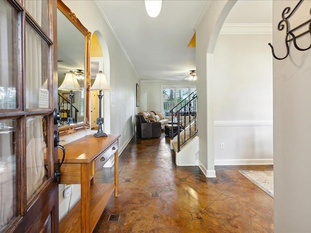 entrance foyer with ceiling fan and crown molding