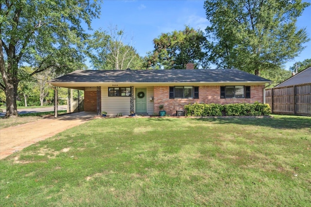 ranch-style house featuring a front yard and a carport