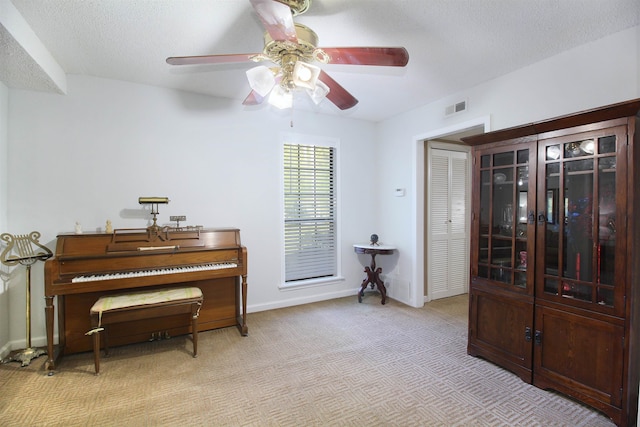 miscellaneous room with a textured ceiling and ceiling fan