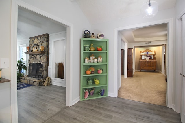 corridor featuring vaulted ceiling and hardwood / wood-style flooring