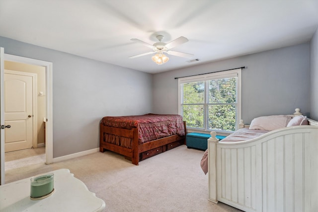 bedroom with ceiling fan and light colored carpet