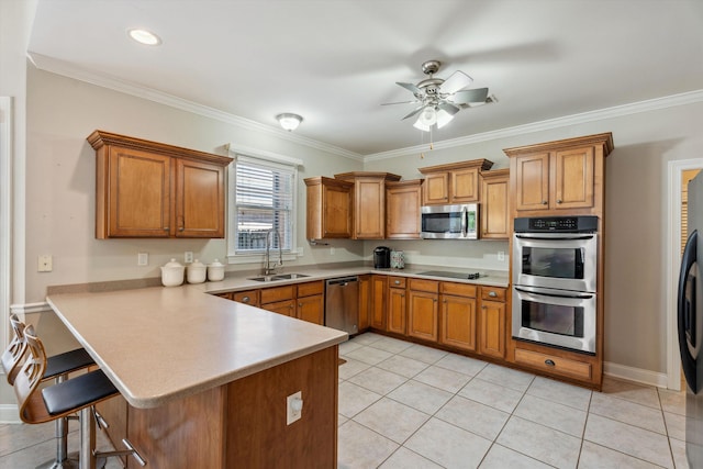 kitchen with ceiling fan, stainless steel appliances, sink, kitchen peninsula, and crown molding