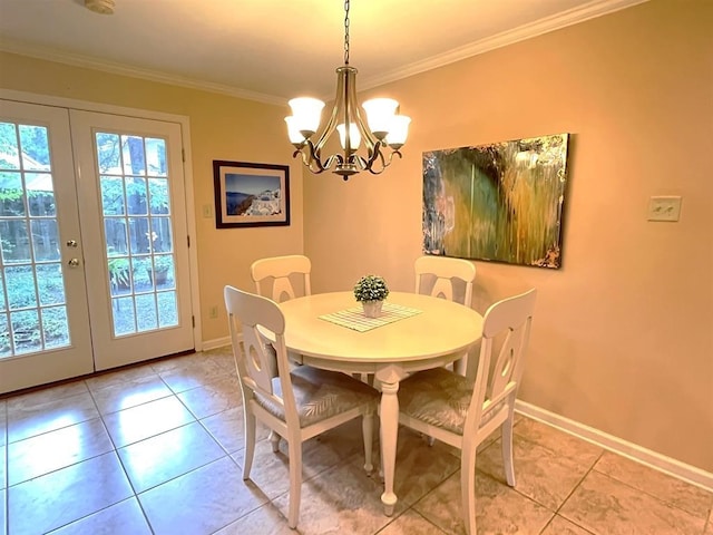 tiled dining space with french doors, crown molding, and a notable chandelier