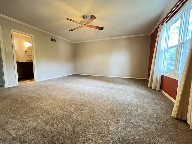 carpeted empty room featuring crown molding and ceiling fan