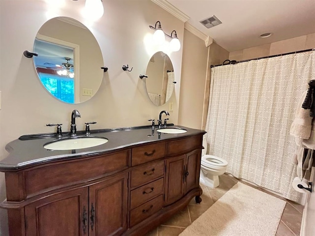 bathroom featuring toilet, ceiling fan, vanity, crown molding, and tile patterned flooring