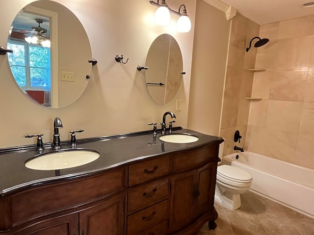 full bathroom featuring toilet, tile patterned flooring, tiled shower / bath combo, vanity, and ceiling fan