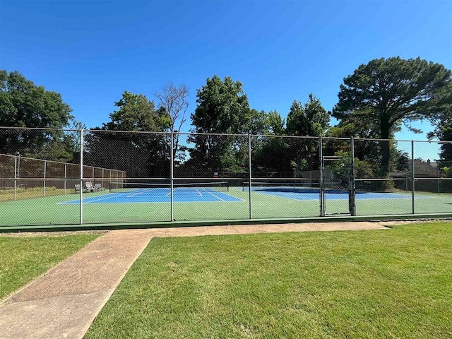 view of sport court with a yard