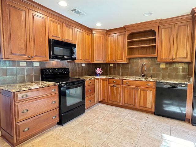 kitchen featuring decorative backsplash, sink, black appliances, light stone countertops, and light tile patterned floors