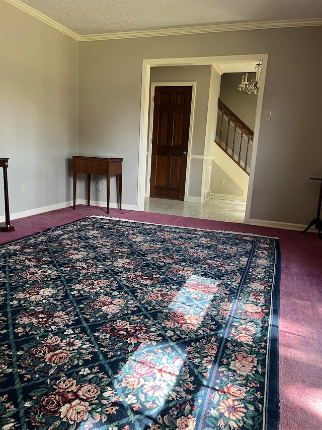 interior space featuring crown molding and a textured ceiling