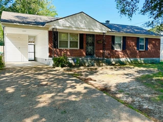 single story home featuring a carport