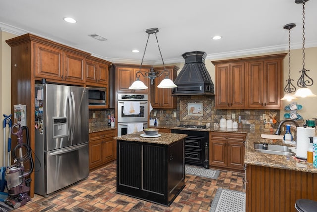 kitchen with decorative backsplash, a kitchen island, pendant lighting, stainless steel appliances, and sink