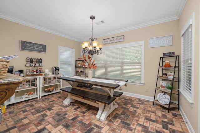 dining space featuring a chandelier and crown molding