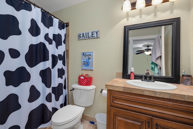 bathroom featuring ceiling fan, vanity, tile patterned floors, a shower with curtain, and toilet