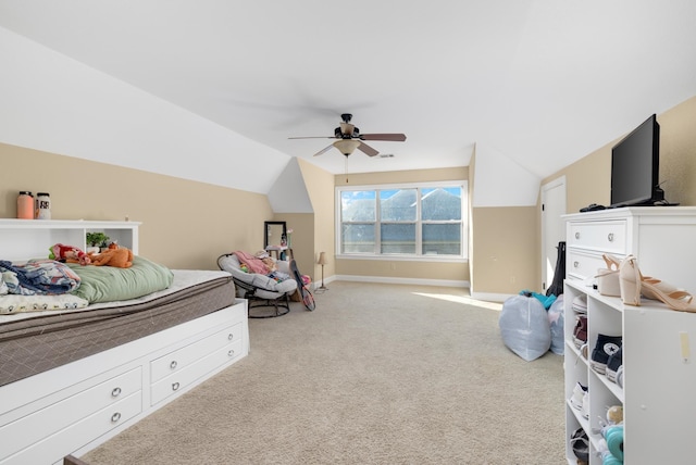 bedroom with vaulted ceiling, ceiling fan, and light colored carpet