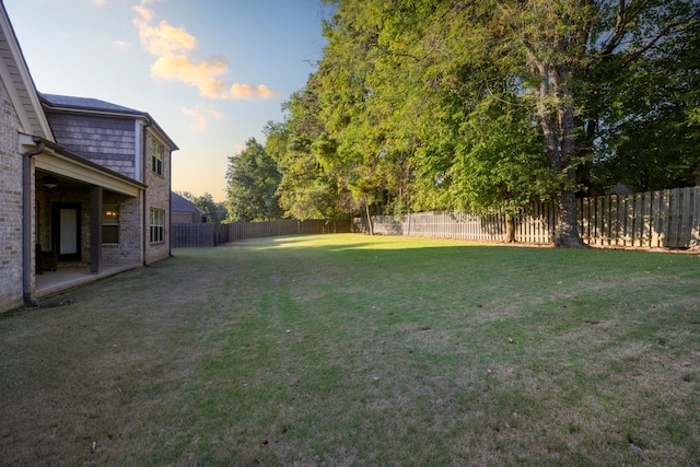 view of yard at dusk