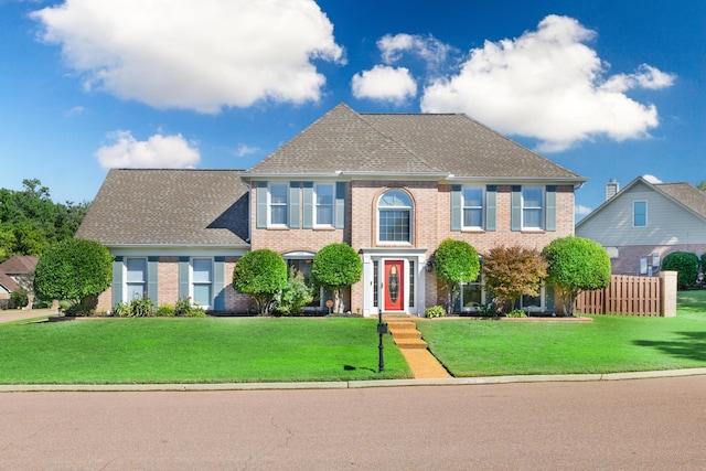 colonial home with a front lawn