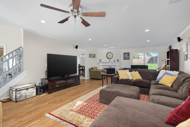 living room featuring crown molding, ceiling fan, and hardwood / wood-style floors