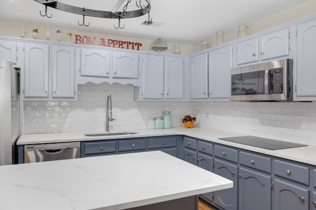 kitchen featuring sink, backsplash, and stainless steel appliances