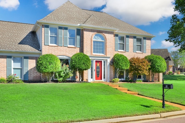 colonial-style house with a front yard