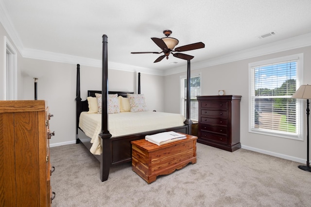 carpeted bedroom featuring crown molding and ceiling fan