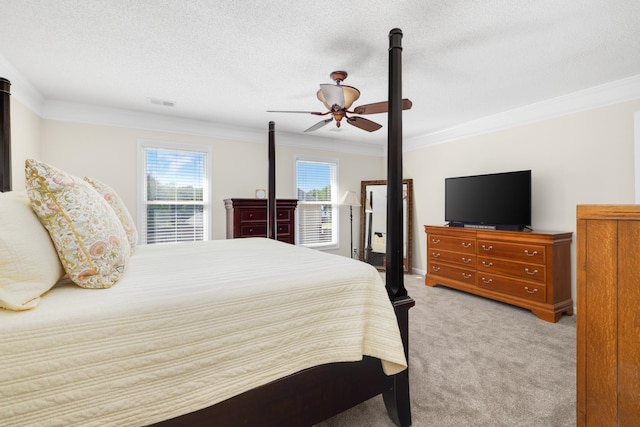 carpeted bedroom featuring ceiling fan, crown molding, and a textured ceiling