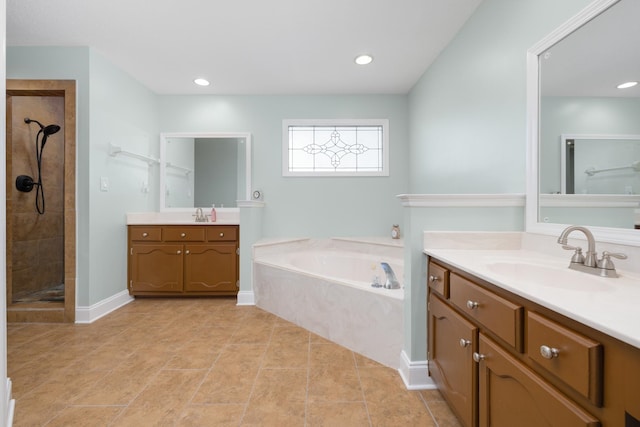 bathroom with vanity and independent shower and bath