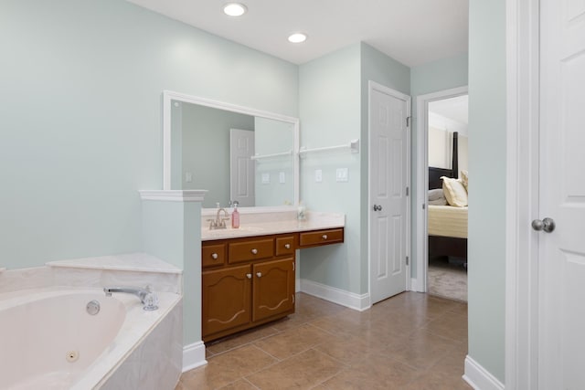 bathroom featuring vanity, tile patterned flooring, and a relaxing tiled tub