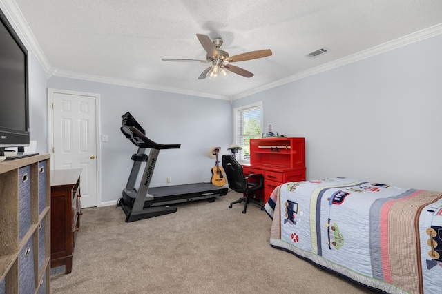 carpeted bedroom with a textured ceiling, ornamental molding, and ceiling fan