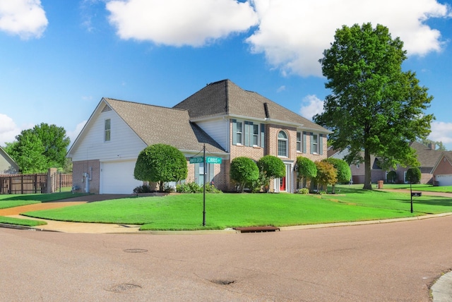 view of front facade featuring a front yard and a garage