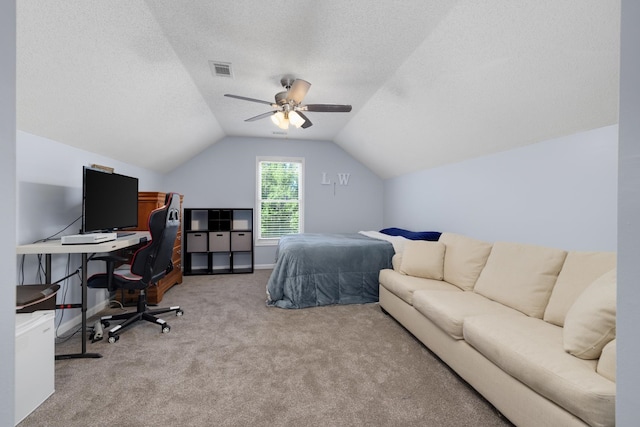 bedroom with ceiling fan, vaulted ceiling, light carpet, and a textured ceiling