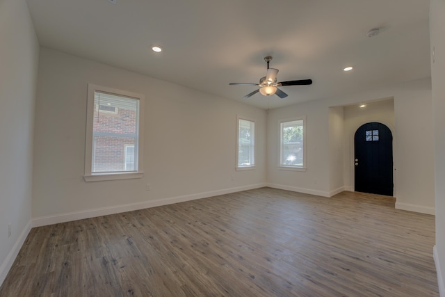 unfurnished room with ceiling fan and light wood-type flooring