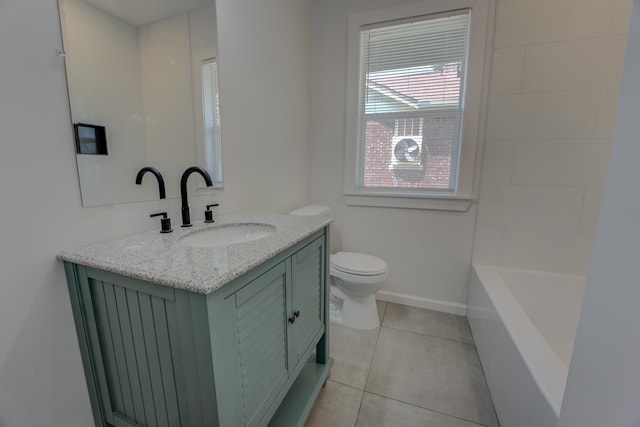 bathroom featuring tile patterned floors, vanity, toilet, and a bathing tub