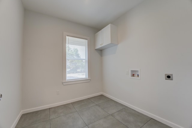 laundry room with cabinets, hookup for a washing machine, hookup for an electric dryer, and light tile patterned floors