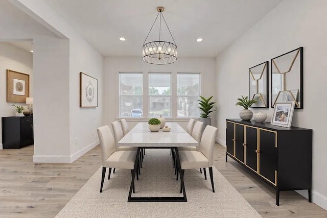 dining area featuring light hardwood / wood-style floors and a chandelier