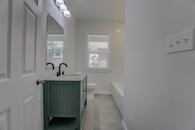 bathroom with vanity, tile patterned flooring, and toilet