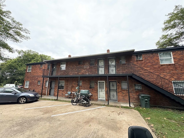 back of property featuring a balcony