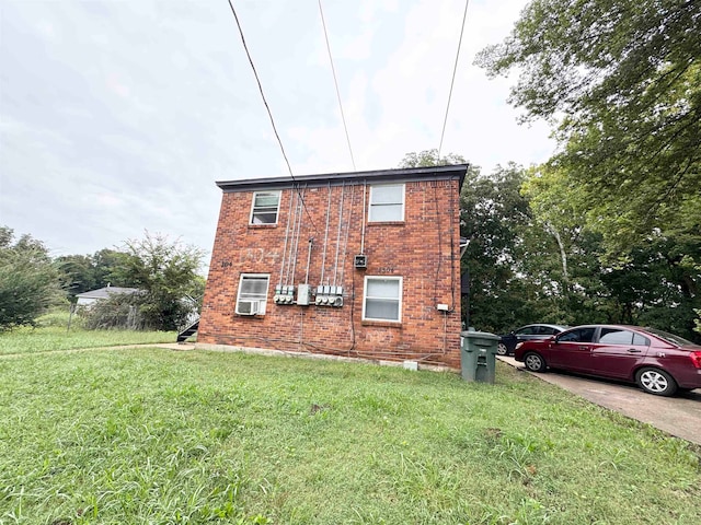 view of side of home with a yard